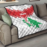 Red-and-white chevron quilt with Lebanon text and green cedar tree, shown on sofa