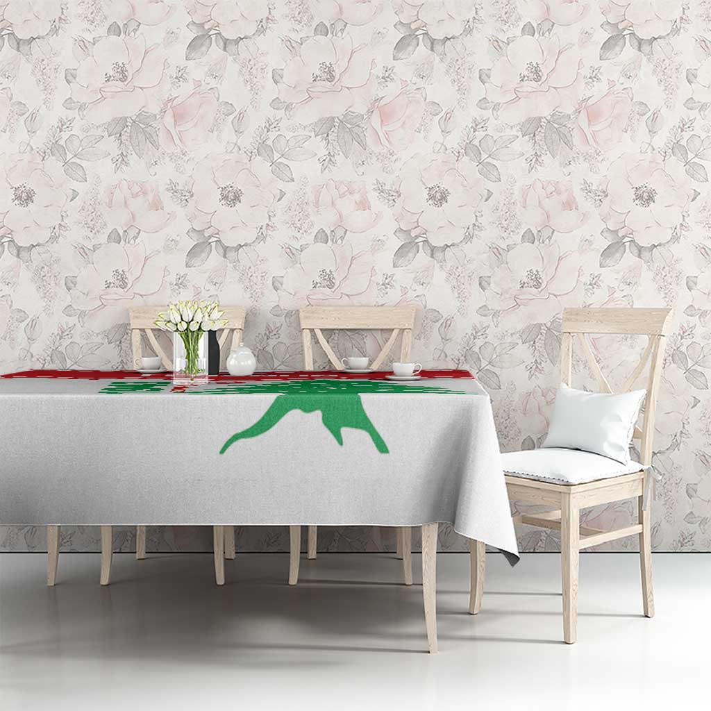 White tablecloth with red stripe and green cedar graphic on dining table