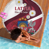 Round beach blanket showing Latvia flag print with daisy accents, burgundy and white, 150cm