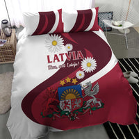 Red and white Latvia duvet cover with flag stripes, crest, and daisy print, with pillows