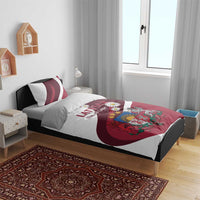 Red and white Latvia duvet cover and pillowcases on bed, with crest and daisy design