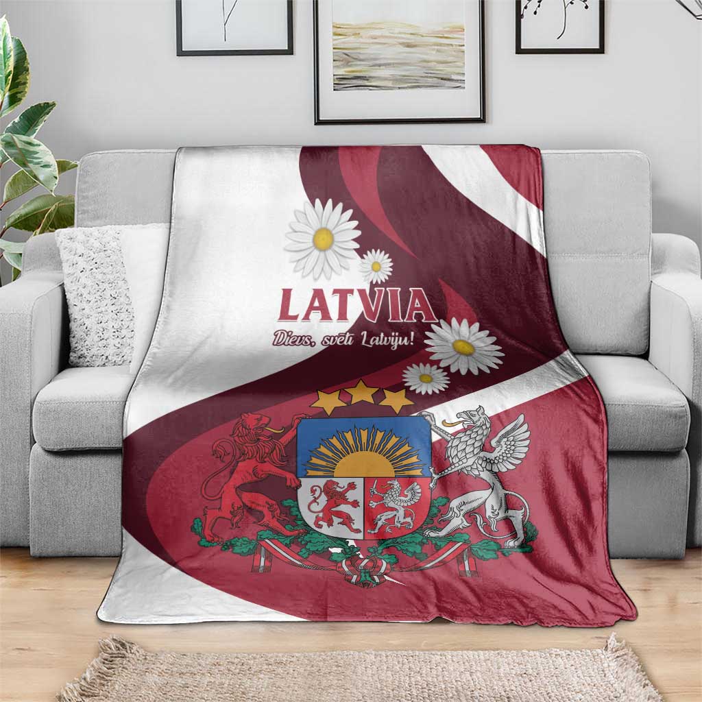 Latvia flag-style blanket with red-and-white stripes, LATVIA text and daisies