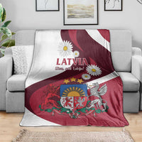 Latvia flag-style blanket with red-and-white stripes, LATVIA text and daisies