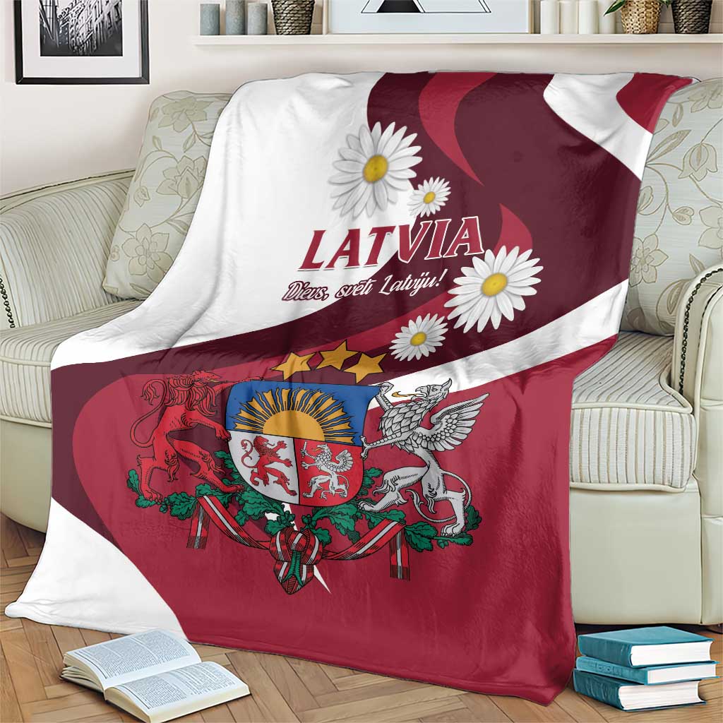 Latvia flag-style blanket showing LATVIA lettering, daisies, and crest on red field