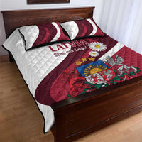Red and white quilt and two striped pillows featuring Latvia crest and daisy artwork