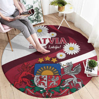 Red round area rug with Latvia lettering, daisies, and heraldic lion and eagle crest