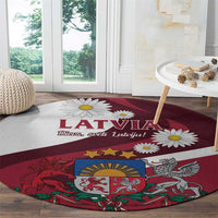 Red round area rug with Latvia text, daisies, and heraldic symbols