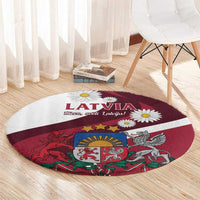 Red round area rug with Latvia lettering and daisies over a crest illustration