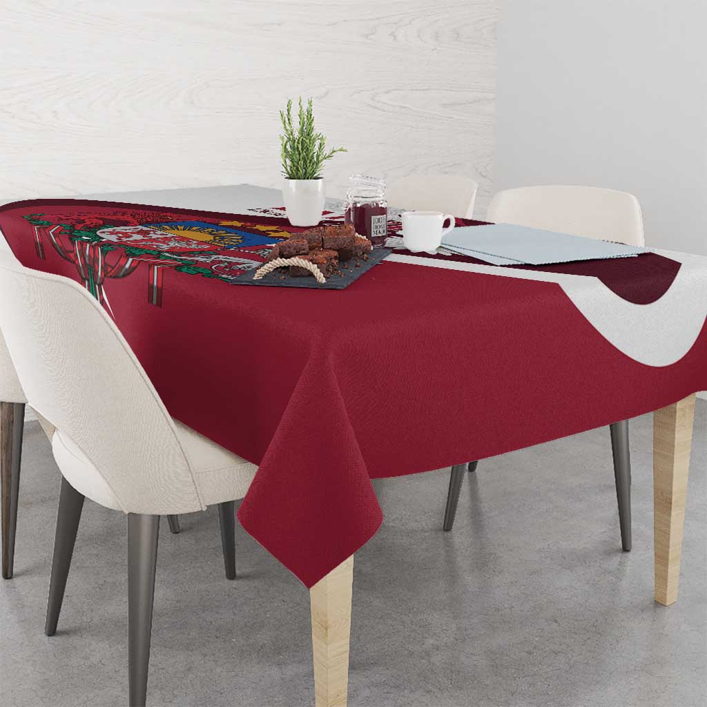 Red tablecloth corner detail with crest and white daisy motifs