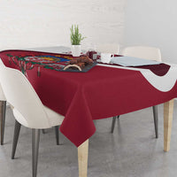 Red tablecloth corner detail with crest and white daisy motifs