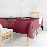 Red tablecloth with crest medallion and patterned border on table