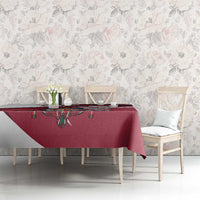 Red tablecloth on dining table featuring crest design and daisy accents