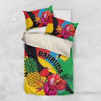 Flat-lay view of tropical bedding set with duvet and two pillowcases featuring BARBUDA and birds