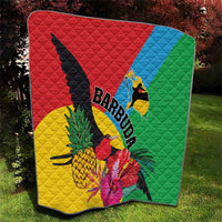 Quilted tropical blanket with bird, pineapple and hibiscus prints in red, green, blue, yellow.