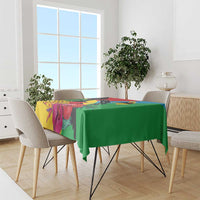 Tropical tablecloth draped on dining table with green solid panel and bird print