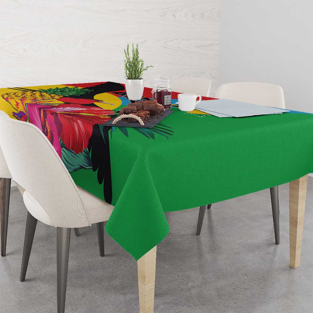 Tropical bird tablecloth with green center panel and colorful leaf and flower design