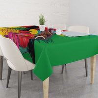 Tropical bird tablecloth with green center panel and colorful leaf and flower design