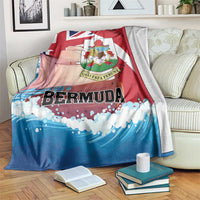 Red, white, and blue Bermuda-themed blanket draped over a sofa with large crest print