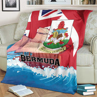 Red, white, and blue Bermuda-themed blanket folded over cushions, showing crest and “BERMUDA”