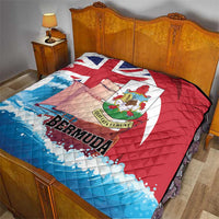 Bermuda quilt throw blanket on bed, quilted red and blue design with crest and logo
