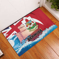 Red rubber doormat with Bermuda text, crest, sailboat and Union Jack pattern