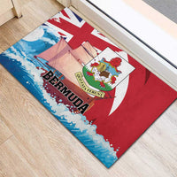 Red rubber doormat showing Bermuda title, crest, sailboats and Union Jack rays