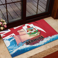 Red rubber doormat with Bermuda text, crest medallion, sailboats and waves