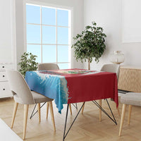Red and blue wave-pattern tablecloth draped over a dining table with chairs