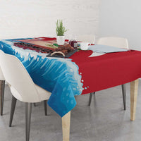 Corner view of red and blue wave-pattern tablecloth on dining table with dishes