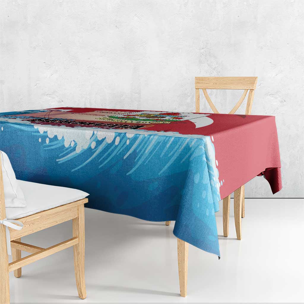 Close view of blue wave-pattern tablecloth with red border draped over bench