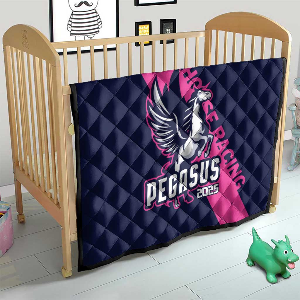 Navy and pink quilt with Pegasus 2025 emblem, placed in a crib.