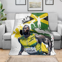 Jamaica blanket over sofa with white, green, and yellow athlete graphic