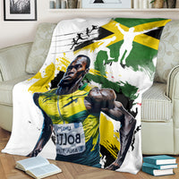Jamaica blanket on couch with large white background and Jamaica athlete print