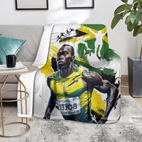 Jamaica blanket on gray couch with white base and green/yellow athlete design