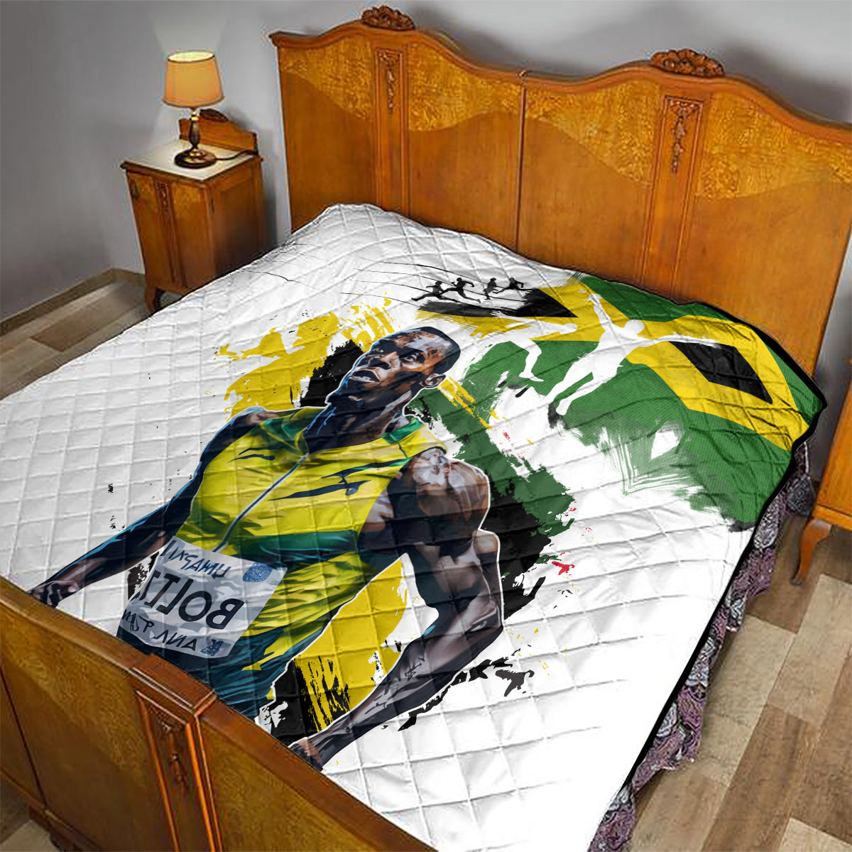White quilt with Jamaica flag and portrait, diamond-quilted surface covering the bed.