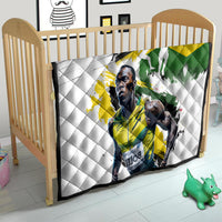 White quilt on child bed/crib, Jamaica flag graphic with diamond-quilted white backing.