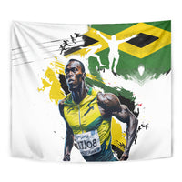 Close-up of white fabric tapestry with Jamaican flag green/yellow and athlete illustration.