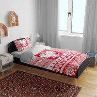 Polish Christmas bedding set on a bed with red-and-white eagle emblem and patterned duvet