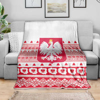 Christmas blanket with Polish eagle emblem, red geometric motifs, and white background
