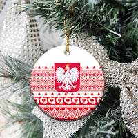 Round Poland emblem ceramic ornament with red-and-white folk pattern, hanging on evergreen