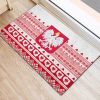 White rubber doormat showing large Polish eagle crest over red folk border stripes