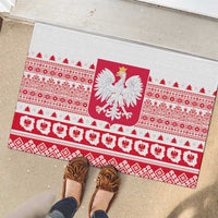 White rubber doormat with Polish eagle crest and red folk border beneath doorway