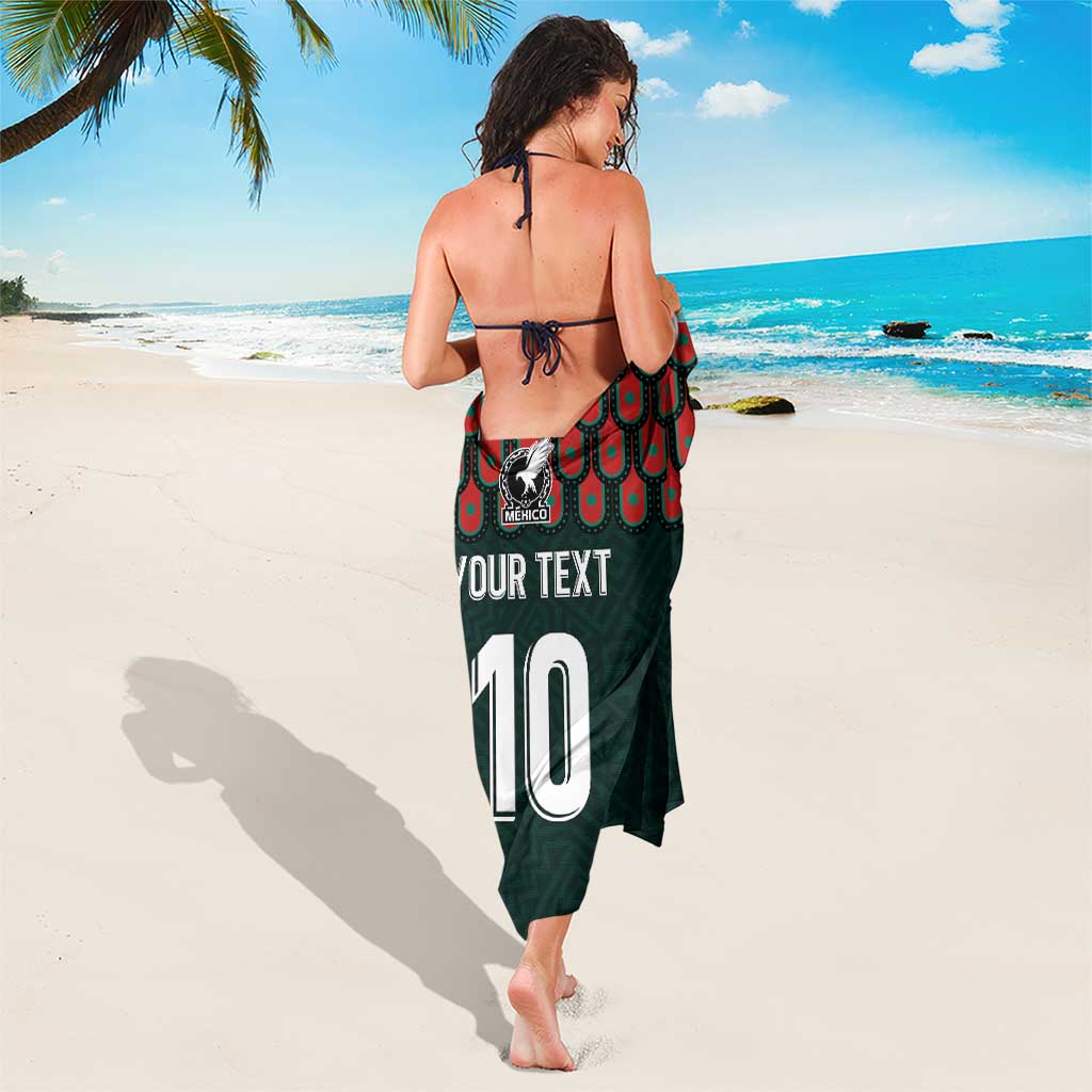 Dark green sarong with red scallop trim, tied shoulder straps, '10' back print