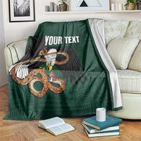 Green throw blanket with eagle-and-serpent graphic and 'YOUR TEXT' text.