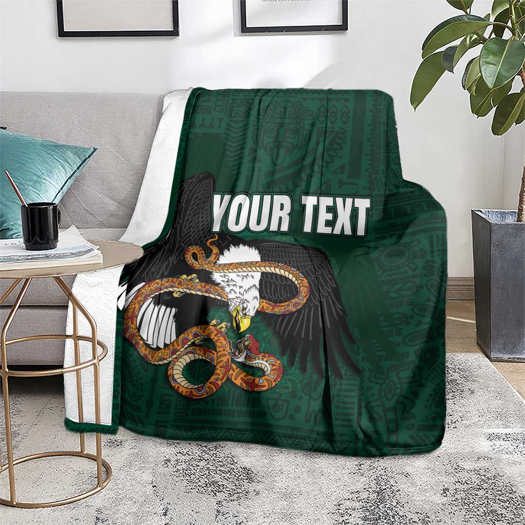 Green throw blanket with eagle-and-serpent graphic and 'YOUR TEXT' text on surface.