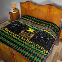 Black quilted bedspread with green diamond pattern, yellow zigzag trim, and Jamaica Christmas lion