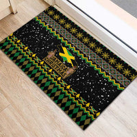 Black doormat with Jamaica Christmas text, reggae zigzag pattern in green and yellow