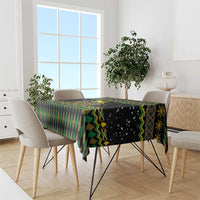 Geometric reggae-style tablecloth in black, green, and yellow with patterned border