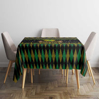 Black tablecloth with green chevron and yellow accents covering a square table