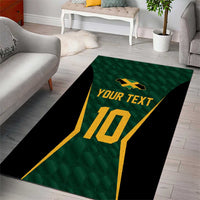 Green area rug with black edge, gold number 10, and 'YOUR TEXT' in center
